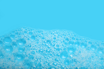 Background soap suds (foam) and bubbles from detergent. House cleaning concept.