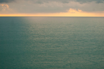 Green sea at sunset, dramatic sky over the Black sea.