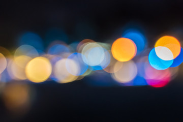 Colored unfocused lights on black background