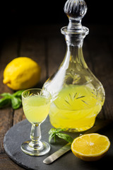 Traditional italian lemon liqueur limoncello and fresh citrus lemon. Alcoholic beverage.