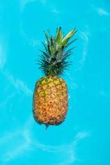 A delicious ripe pineapple floating in a pool - Sweet exotic pineapple