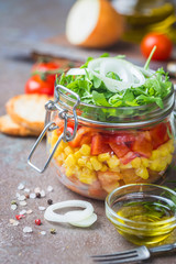 Healthy Homemade Mason Jar Vegetables Salad with tomatoes, corn, pepper, arugula and onion