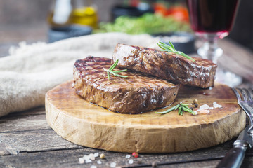 Grilled marbled meat steak Filet Mignon with seasonings. Juicy beef steak on cutting board.