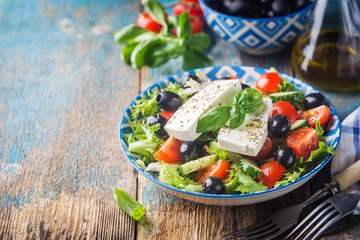 Fresh Greek salad of cucumber, tomato, sweet pepper, red onion, feta cheese and olives with olive oil. Healthy food