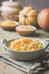 Millet porridge with sweet pumpkin in a bowl, rustic style. Healthy vegan dish.