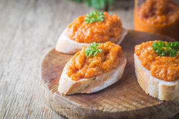 Homemade caviar of zucchini on a slice of bread in rustic style