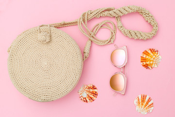 Travel feminine accessories on pink backgropund. Flat lay