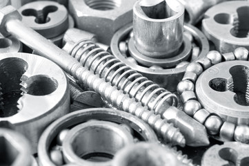 Mechanical ratchets nuts and bolts closeup, toned image