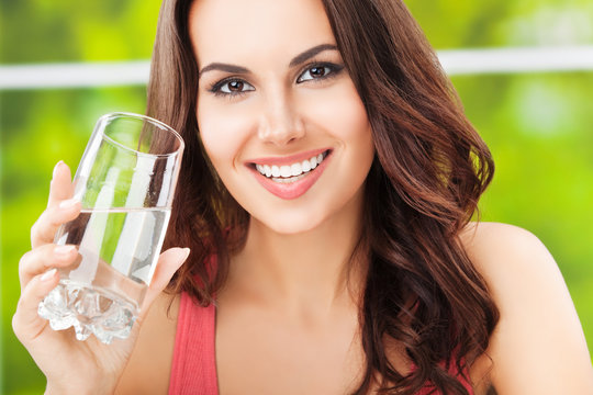 young happy attractive woman with glass of water