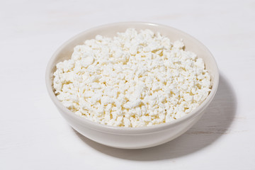bowl of fresh farm cottage cheese on a white background