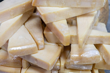 Parmesan pieces wrapped in transparent plastic sold at farmers market
