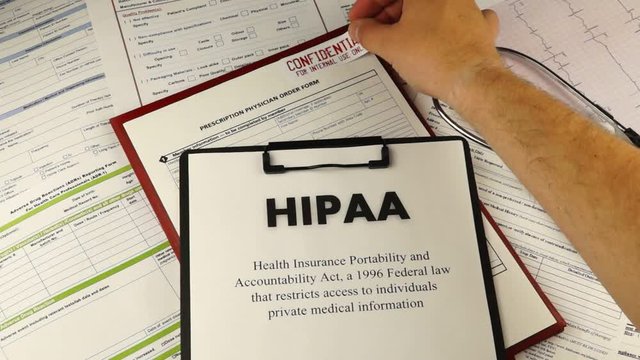 Health Insurance Portability and accountability act HIPAA, red folder with inscription confidential, medication request form and stethoscope on a blue velvet background. Close-up