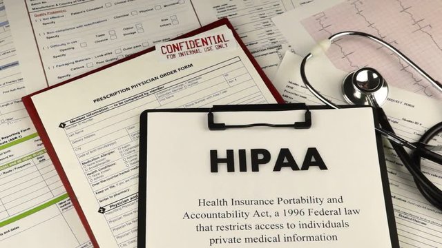 Health Insurance Portability and accountability act HIPAA, red folder with inscription confidential, medication request form and stethoscope on a blue velvet background. Close-up