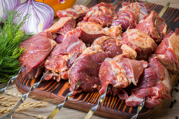Fresh raw meat skewers kebabs. Meat prepared for marinating on cutting board.