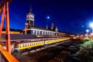 Fototapeta na wymiar Twilight scenery with clearly sky and moon at Dunedin Train Station in South Island, New Zealand.
