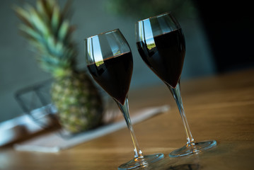Pouring red wine on a wooden oak table
