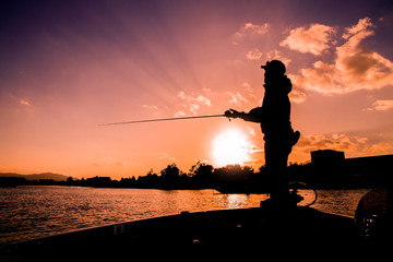 Angler on the boat in the lake