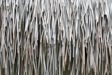 The texture of the roof made from dry palm leaves closeup. Tropical background
