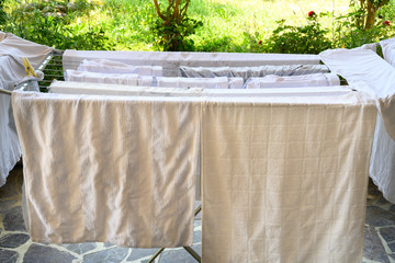 White clothes and linens that need to be washed or that have been newly washed.