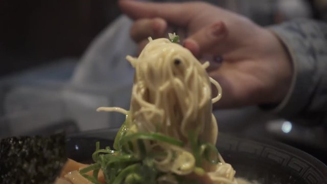 lifting up Ramen with chopstick in slow mo