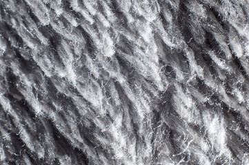 Gray fleecy fabric of a warm plaid close-up macro shot