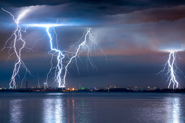 strong thunderstorm with lightning over the city