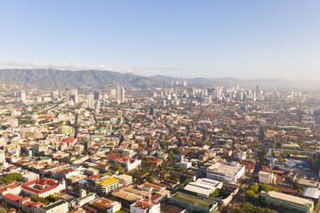 Cityscape in the morning. The streets and houses of the city of Cebu, Philippines, top view. Panorama of the city with houses and business centers.