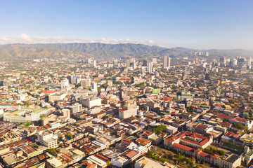 Cityscape in the morning. The streets and houses of the city of Cebu, Philippines, top view. Panorama of the city with houses and business centers.