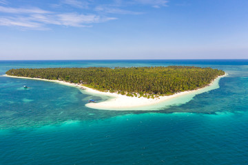 Patongong Island, Palawan, Philippines. Tropical island with palm forest and white sand. Atoll with a green island, view from above.