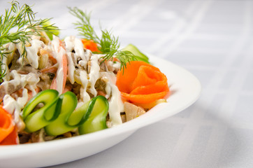 salad of boiled beef, champignons, carrots, pickled cucumbers, onions and lettuce seasoned with mayonnaise
