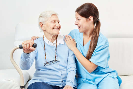 Female nursing assistant and happy senior citizen