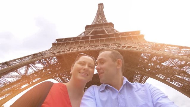 Couple taking selfie with a view of Eiffel Tower in Paris in 4k slow motion 60fps