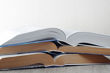 A stack of big study open books