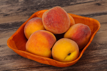 Peach heap in the wooden basket