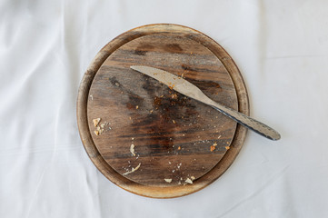Empty wooden tray with cutlery and bread crumb