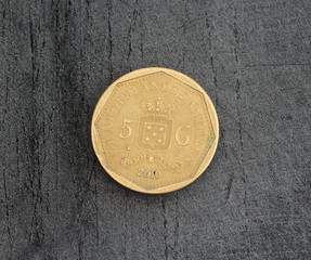 one Netherlands Antillean guilder coin on black background