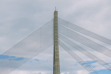 Fototapeta premium City Riga, Latvia Republic. Urban city cable bridge and river. Old metal constructions. July 4. 2019