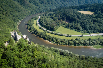Fototapeta na wymiar Domasinsky meander of Vah river, Starhrad ruins castle with road around, meadows, forest and hills of Lucanska Mala Fatra mountains, Slovakia