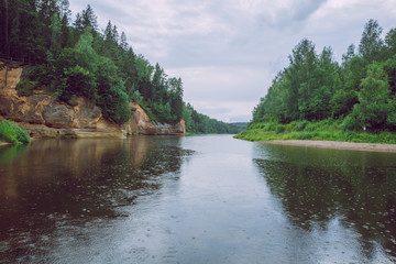 City Cesis, Latvia Republic. Red rocks and river Gauja. Nature  and green trees in summer. July 4. 2019 Travel photo.