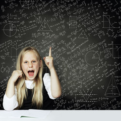 Cute smart child student girl have idea. blackboard background with science formulas. Learning science concept.