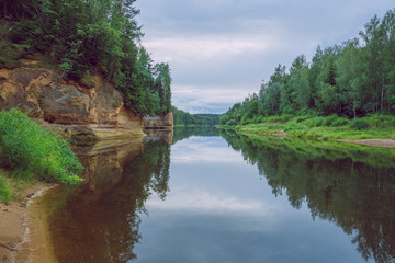 City Cesis, Latvia Republic. Red rocks and river Gauja. Nature  and green trees in summer. July 4. 2019 Travel photo.