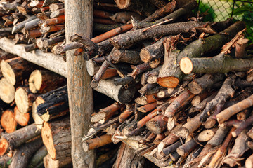 Preparation of firewood for the winter. Firewood background. Stacks of firewood.