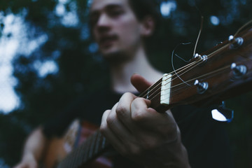 Man playing on guitar close up, playing guitar, musician, hand and fingers, music background