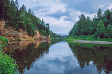 Fototapeta na wymiar City Cesis, Latvia Republic. Red rocks and river Gauja. Nature and green trees in summer. July 4. 2019 Travel photo.