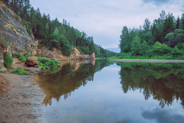 Obraz premium City Cesis, Latvia Republic. Red rocks and river Gauja. Nature and green trees in summer. July 4. 2019 Travel photo.