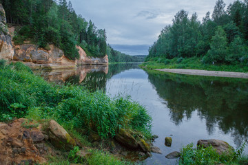Fototapeta na wymiar City Cesis, Latvia Republic. Red rocks and river Gauja. Nature and green trees in summer. July 4. 2019 Travel photo.