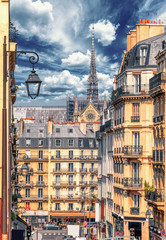 Latin Quarter street view of Paris, France. Blue sky, buildings and traffic. Shot in april daylight with Notre Dame in the background.