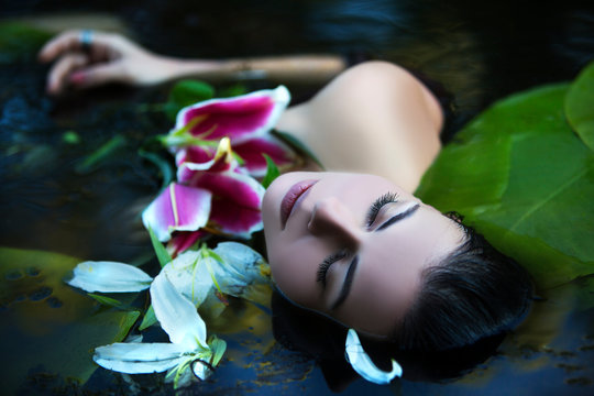 Beautiful Sexy Woman Bathes In A Lake With Water Lilies