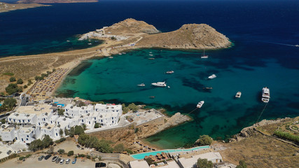 Aerial drone photo of small peninsula with picturesque chapel and beach of Agia Anna as well as small beach of Divounia, island of Mykonos, Cyclades, Greece