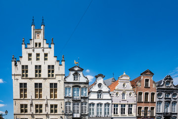 stepped gable, facades of houses on main square called Grote Markt in Mechelen, Belgium. Blue sky, space for text